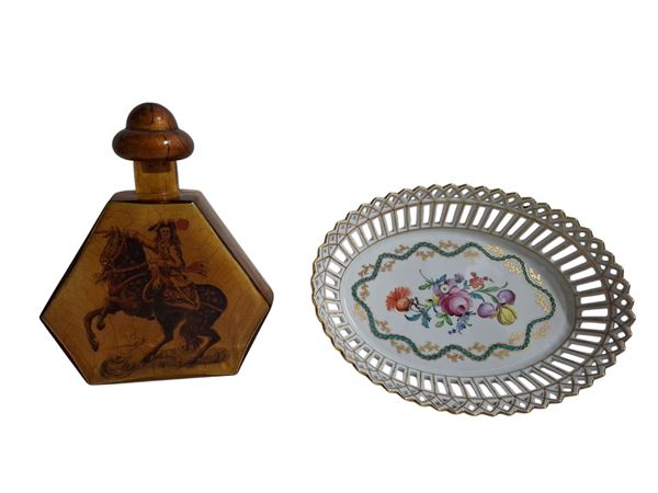 a) Bottiglia da liquore con tappo, decorata con cavaliere a cavallo; b) Cestino in porcellana di Dresda, decorato con motivi floreali