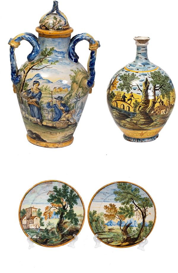Castelli d'Abruzzo, XVIII secolo - a)POTICHE BIANSATA in maiolica dipinta in policromia - h cm 42; b)BOTTIGLIA DA FARMACIA in maiolica dipinta in policromia - h. cm 31; c)COPPIA DI PIATTI in maiolica dipinta in policromia con paesaggi alberati - cm 18,5 cad.