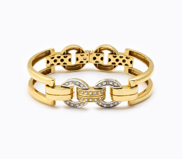 Bracciale anni '70 semirigido  - in oro giallo e bianco 18 carati - Auction JEWELRY, WATCHES AND SILVER OBJECTS - Blindarte Casa d'Aste